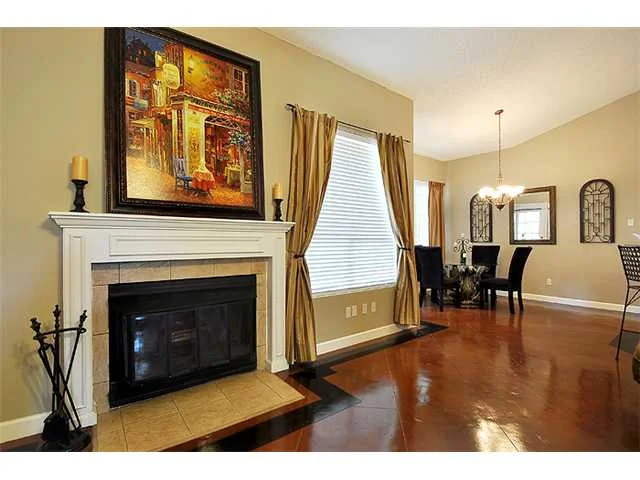 Warm brown stained and sealed concrete in a living room with a fireplace